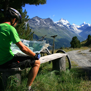 En un circuito de autoguiado, ciclista de montaña leyendo su mapa